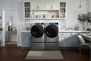 Whirlpool front load washer and dryer set installed in a modern laundry room. 