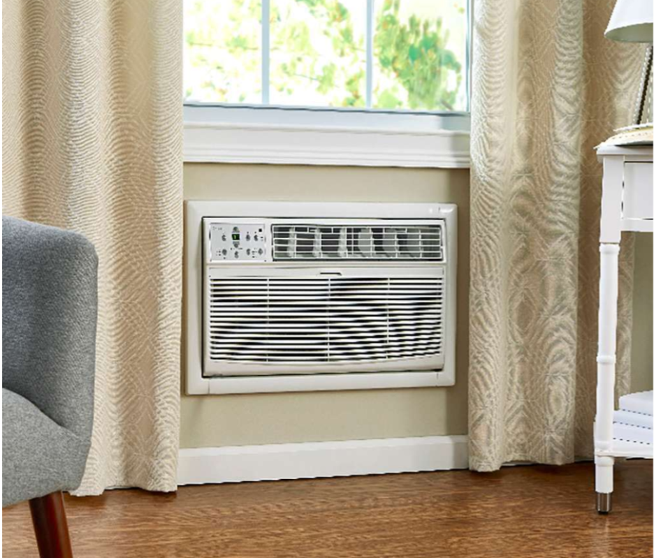 Midea through-the-wall air conditioner installed in a living room wall. 